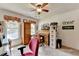 Well-lit bedroom with a cozy desk, bright window, and carpet flooring at 1019 Wolf Springs Ct, Lawrenceville, GA 30043