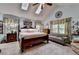 Spacious bedroom featuring a four-poster bed, skylights, and neutral color scheme at 1019 Wolf Springs Ct, Lawrenceville, GA 30043