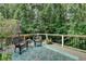 Charming deck space with wicker chairs, an umbrella table, and serene green backyard views at 1019 Wolf Springs Ct, Lawrenceville, GA 30043