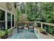Inviting outdoor deck featuring wicker furniture, a starfish rug, and views of the lush backyard at 1019 Wolf Springs Ct, Lawrenceville, GA 30043