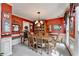 Dining room with vibrant red walls, a chandelier, and a view to the kitchen at 1019 Wolf Springs Ct, Lawrenceville, GA 30043