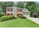 Attractive two-story home featuring well-kept lawn, vibrant red shutters, and a two-car garage at 1019 Wolf Springs Ct, Lawrenceville, GA 30043