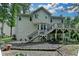 Exterior view of the home featuring a multi-level deck and landscaped backyard at 1019 Wolf Springs Ct, Lawrenceville, GA 30043