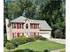 Traditional two-story home featuring red shutters, a green lawn, and an attached two-car garage at 1019 Wolf Springs Ct, Lawrenceville, GA 30043