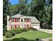 Charming two-story home featuring a well-manicured lawn, bright red shutters, and an attached two-car garage at 1019 Wolf Springs Ct, Lawrenceville, GA 30043