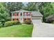 Inviting two-story home features red shutters, a well-maintained lawn, and an attached garage at 1019 Wolf Springs Ct, Lawrenceville, GA 30043