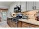 Kitchen with granite countertops, stainless steel appliances, and classic white cabinets at 1019 Wolf Springs Ct, Lawrenceville, GA 30043