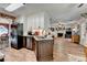 Open kitchen features stainless steel appliances, granite counters, and wood-look floors at 1019 Wolf Springs Ct, Lawrenceville, GA 30043