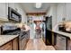 Galley kitchen view to dining area showcasing stainless steel appliances and granite countertops at 1019 Wolf Springs Ct, Lawrenceville, GA 30043