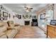Inviting living room featuring a fireplace, hardwood floors, and abundant natural light through large windows at 1019 Wolf Springs Ct, Lawrenceville, GA 30043