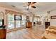 Open-concept living room featuring hardwood floors flowing into the dining area at 1019 Wolf Springs Ct, Lawrenceville, GA 30043