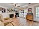 Inviting living room featuring a fireplace, hardwood floors, and abundant natural light at 1019 Wolf Springs Ct, Lawrenceville, GA 30043