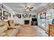 Inviting living room featuring a fireplace, hardwood floors, and abundant natural light through large windows at 1019 Wolf Springs Ct, Lawrenceville, GA 30043