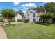 Charming two-story home featuring a manicured lawn and well-maintained landscaping at 1430 Grovehurst Dr, Marietta, GA 30062