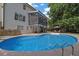 Backyard pool featuring a large patio and a screened-in porch for outdoor entertaining at 1430 Grovehurst Dr, Marietta, GA 30062