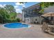 Inviting backyard pool with patio seating, covered porch, and meticulously kept landscaping at 1430 Grovehurst Dr, Marietta, GA 30062