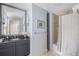 Bathroom with granite counters, cabinet, and a shower with curtain at 195 14Th St # 902, Atlanta, GA 30309