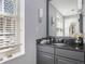 Stylish bathroom featuring granite counters and a window with blinds at 195 14Th St # 902, Atlanta, GA 30309
