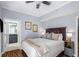 Cozy bedroom features a queen size bed, hardwood floors, ceiling fan, and ensuite bathroom at 195 14Th St # 902, Atlanta, GA 30309