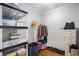 A simple closet with laminate flooring, neutral-colored walls, and shelving at 195 14Th St # 902, Atlanta, GA 30309