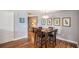 The dining room features a modern light fixture, gray walls, and wood floors at 195 14Th St # 902, Atlanta, GA 30309