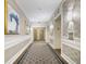 Hallway with decorative panels, patterned carpeting, and elegant sconces, leading to elevators and suites at 195 14Th St # 902, Atlanta, GA 30309
