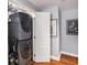 Laundry room with stacked washer and dryer and laminate flooring at 195 14Th St # 902, Atlanta, GA 30309