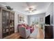 Bright living room with cozy seating, a ceiling fan, and a sliding glass door to a balcony with city views at 195 14Th St # 902, Atlanta, GA 30309