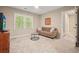 Comfortable bedroom with a cozy couch, a window bringing in plenty of light, and fresh carpet at 3267 Standing Peachtree Trl, Kennesaw, GA 30152