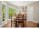 Bright breakfast nook featuring large windows and a wooden table at 3267 Standing Peachtree Trl, Kennesaw, GA 30152