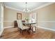 Classic dining room features a chandelier, hardwood floors, and seating for four at 3267 Standing Peachtree Trl, Kennesaw, GA 30152