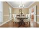 Elegant dining room with chandelier, hardwood flooring, and seating for six at 3267 Standing Peachtree Trl, Kennesaw, GA 30152
