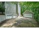 View of home showing multiple garage doors and large driveway at 3267 Standing Peachtree Trl, Kennesaw, GA 30152