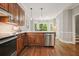 Kitchen featuring stainless oven, custom cabinetry, and beautiful hardwood floors at 3267 Standing Peachtree Trl, Kennesaw, GA 30152