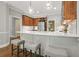 Kitchen with bar stool seating, stainless refrigerator, and beautiful hardwood floors at 3267 Standing Peachtree Trl, Kennesaw, GA 30152
