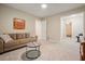 Bright living room featuring a couch, side table, and a glimpse into a connecting bedroom at 3267 Standing Peachtree Trl, Kennesaw, GA 30152