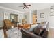Bright living room featuring a fireplace, hardwood floors, ceiling fan, and neutral decor at 3267 Standing Peachtree Trl, Kennesaw, GA 30152