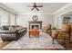 Bright living room featuring a fireplace, hardwood floors, ceiling fan, and neutral decor at 3267 Standing Peachtree Trl, Kennesaw, GA 30152