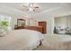 Large main bedroom featuring a king bed, sitting area, and natural light at 3267 Standing Peachtree Trl, Kennesaw, GA 30152