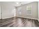 Bright bedroom with ample natural light, hardwood floors, and neutral paint, creating a serene space at 5933 Brookside Oak Cir, Norcross, GA 30093