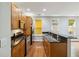 Modern kitchen featuring granite countertops, stainless steel appliances, and rich wood cabinets at 5933 Brookside Oak Cir, Norcross, GA 30093