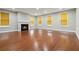 Spacious living room with hardwood floors, fireplace, and abundant natural light from large windows at 5933 Brookside Oak Cir, Norcross, GA 30093