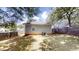 Cozy backyard featuring a well-maintained lawn, privacy fence, and mature trees providing ample shade at 71 Thayer Se Ave, Atlanta, GA 30315