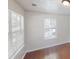 Bright bedroom featuring hardwood floors, fresh paint, and natural light from two windows at 71 Thayer Se Ave, Atlanta, GA 30315