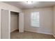Bedroom with natural light, carpet flooring, and a closet for storage at 71 Thayer Se Ave, Atlanta, GA 30315