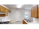 Galley-style kitchen with stainless appliances, wood cabinets, and vinyl flooring at 71 Thayer Se Ave, Atlanta, GA 30315
