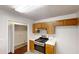 Well-equipped kitchen with stainless steel oven, wood cabinets, and convenient access to laundry room at 71 Thayer Se Ave, Atlanta, GA 30315