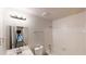 Clean bathroom with tub, vanity, and white tiled walls, providing all the essentials at 1169 Oaks Pl, Stone Mountain, GA 30083