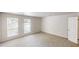 Spacious bedroom with neutral carpet and dual windows, and door for access at 1169 Oaks Pl, Stone Mountain, GA 30083
