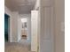 Bright hallway with neutral walls, leading to bathroom and bedroom, illuminated by overhead light at 1169 Oaks Pl, Stone Mountain, GA 30083